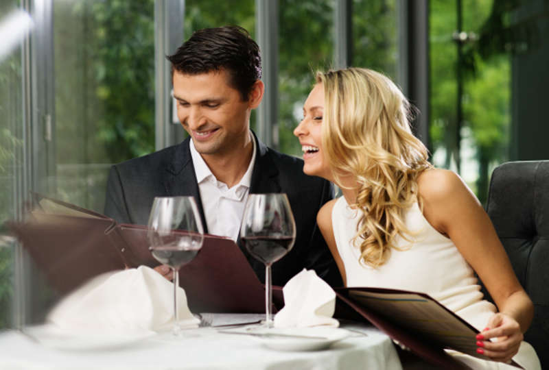 Cheerful couple with menu in a restaurant